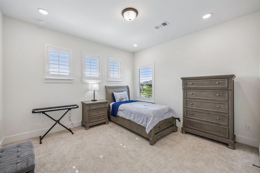Bedroom featuring light colored carpet and recessed lighting