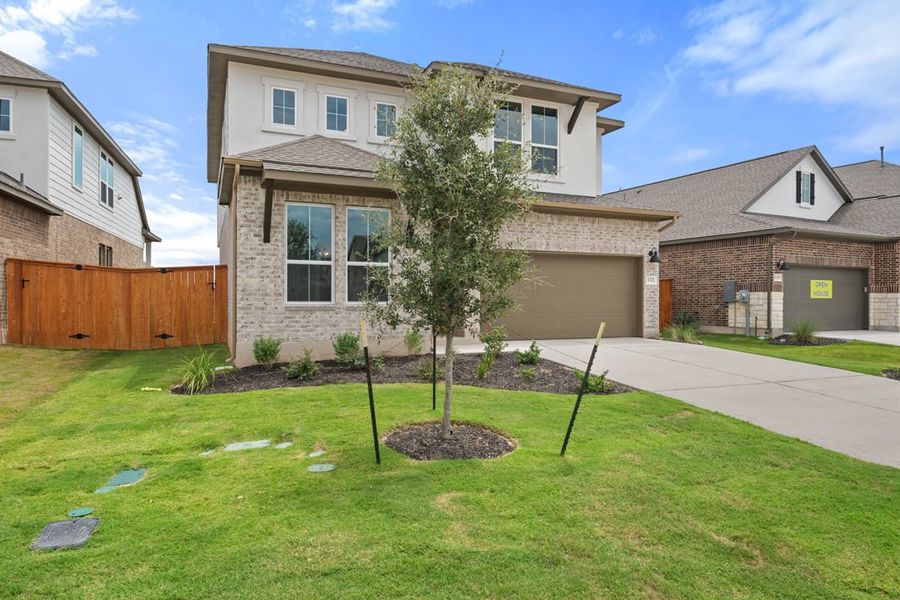 Front exterior of a new home in Arbor Collection at Lariat, Liberty Hill, TX, highlighting curb appeal (Image 23). Front exterior of a new home in Arbor Collection at Lariat, Liberty Hill, TX, highlighting curb appeal (Image 23).