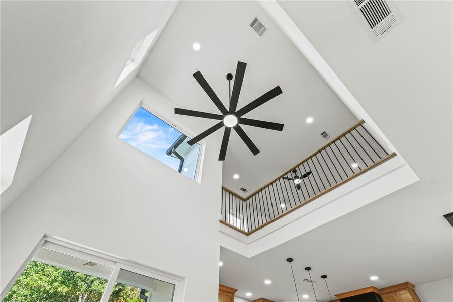 Detailed view of recessed lighting, a skylight, and a ceiling fan