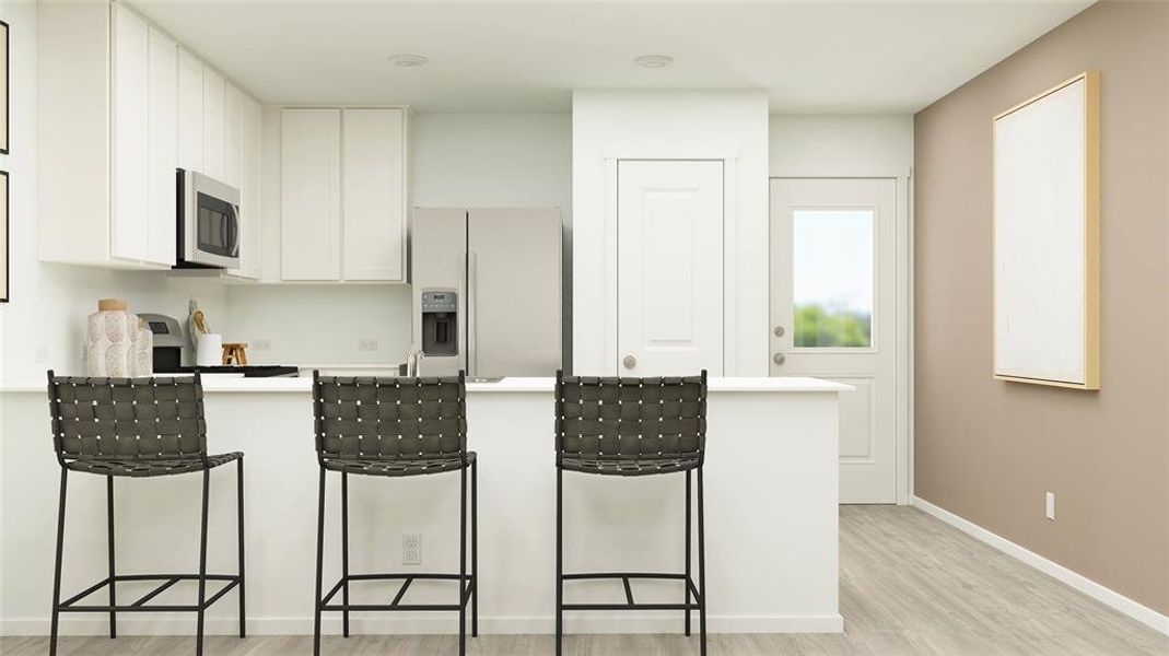 Contemporary kitchen featuring white cabinetry, stainless steel appliances, a white countertop island, and wood-finish flooring Contemporary kitchen featuring white cabinetry, stainless steel appliances, a white countertop island, and wood-finish flooring