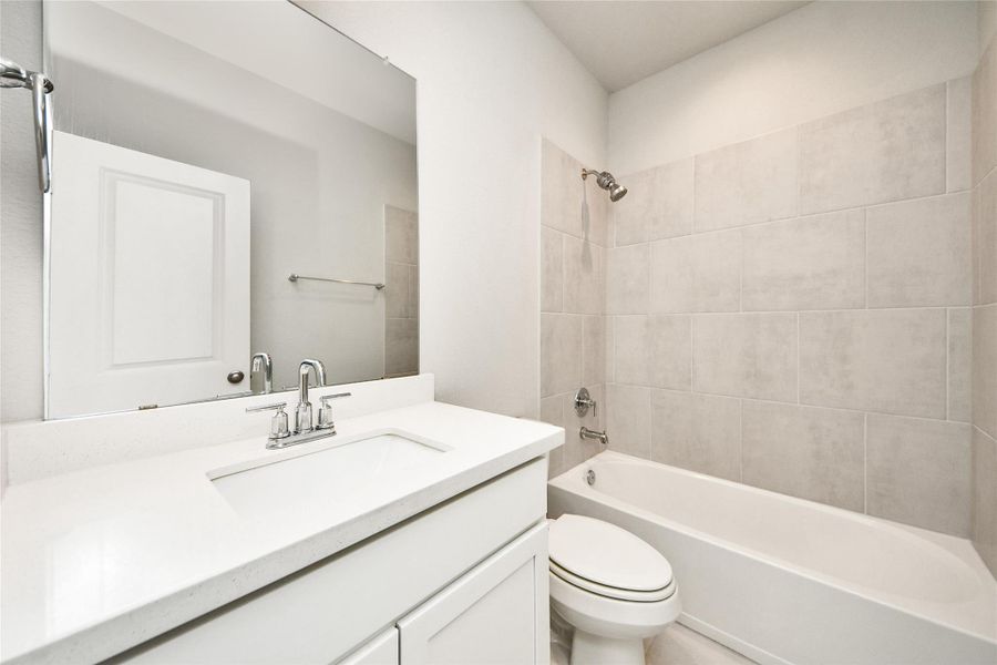 Full bathroom featuring a vanity, tub/shower combination, and contemporary finishes designed for comfort and convenience.