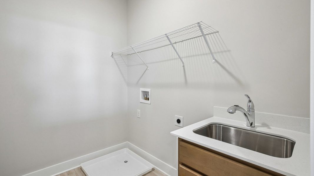 Dedicated laundry room with ventilated shelf Dedicated laundry room with ventilated shelf