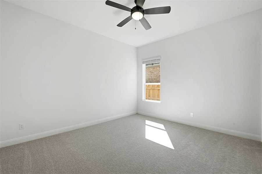 Room featuring light-colored carpeting and a ceiling fan with integrated lighting