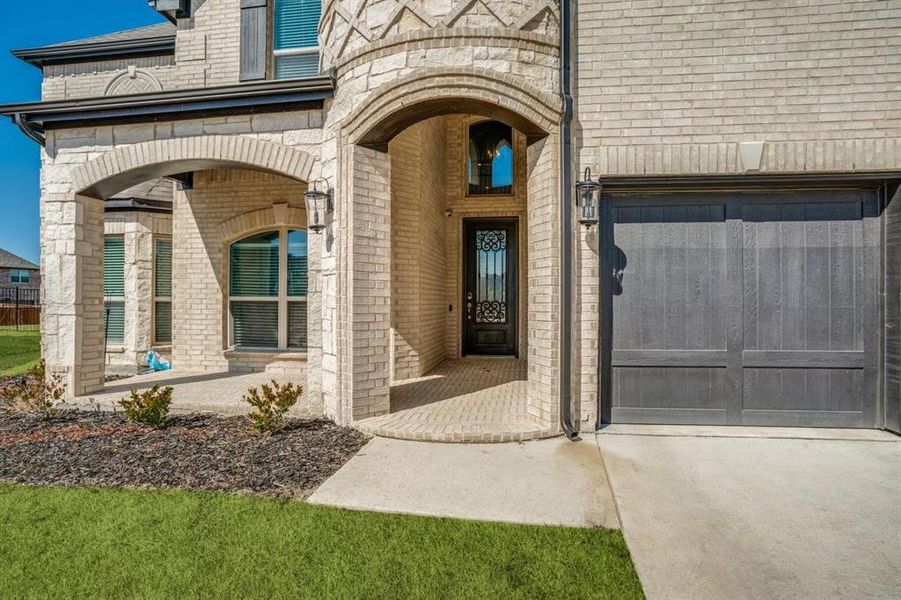 Doorway to property featuring a garage