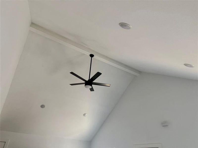 Detailed view of beamed ceiling and a ceiling fan