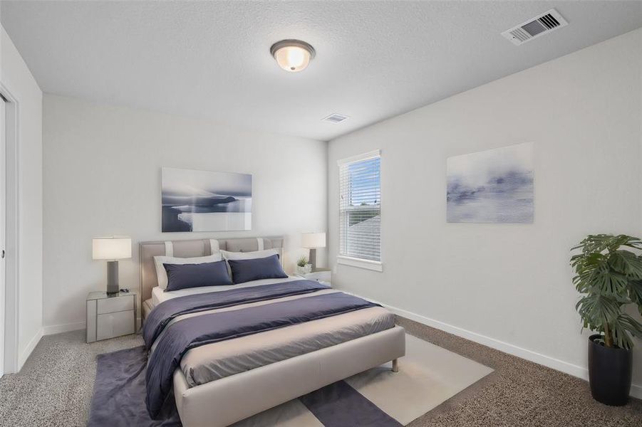 Secondary bedroom features plush carpet, neutral paint, lighting and a large window with privacy blinds.