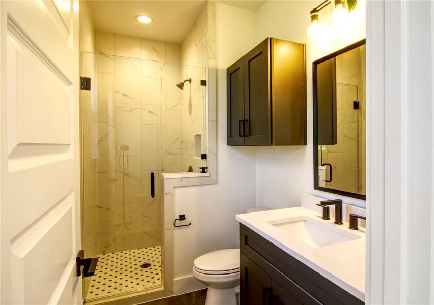 Bathroom with vanity, a marble finish shower, and recessed lighting Bathroom with vanity, a marble finish shower, and recessed lighting