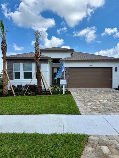 Front exterior of a new home in Valencia Ridge (55+), Wesley Chapel, FL, highlighting curb appeal (Image 1). Front exterior of a new home in Valencia Ridge (55+), Wesley Chapel, FL, highlighting curb appeal (Image 1).