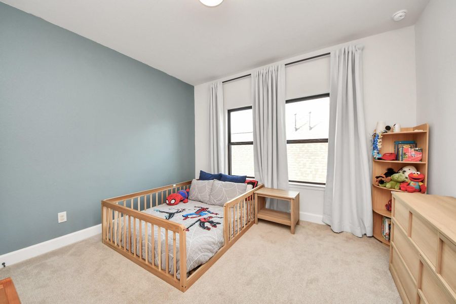 Bright bedroom with ample space for play and study.
