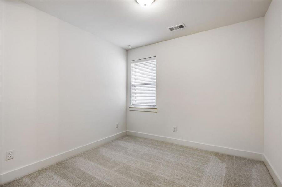 Neutral wall paint, light gray carpet, window with blinds, recessed lighting, and white baseboards
