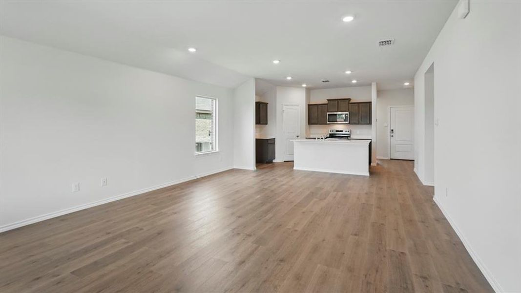 Unfurnished living room with light wood-type flooring and recessed lighting