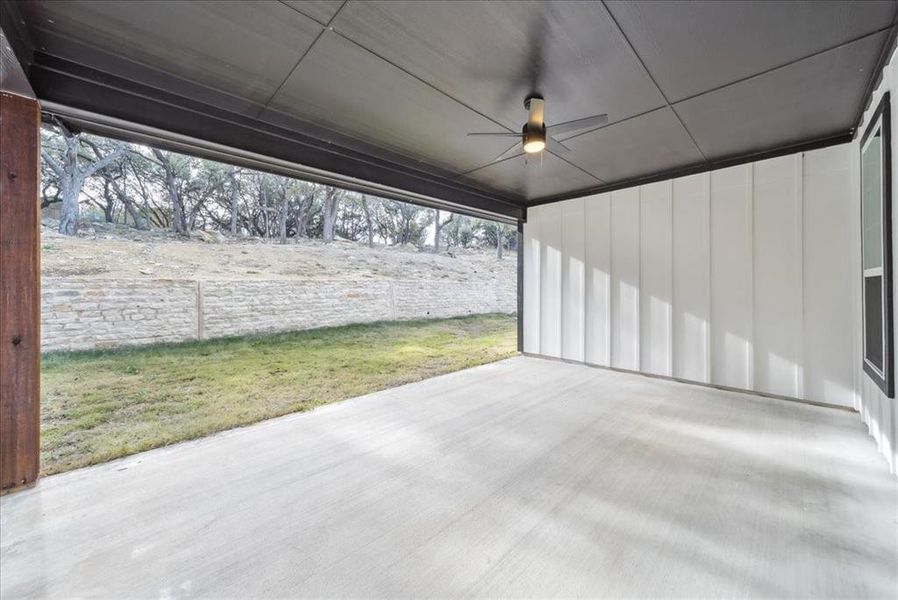 Garage featuring ceiling fan and a lawn