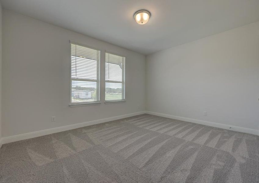 Guest bedroom with two windows and a walk-in closet, providing space for all guests to feel comfortable.