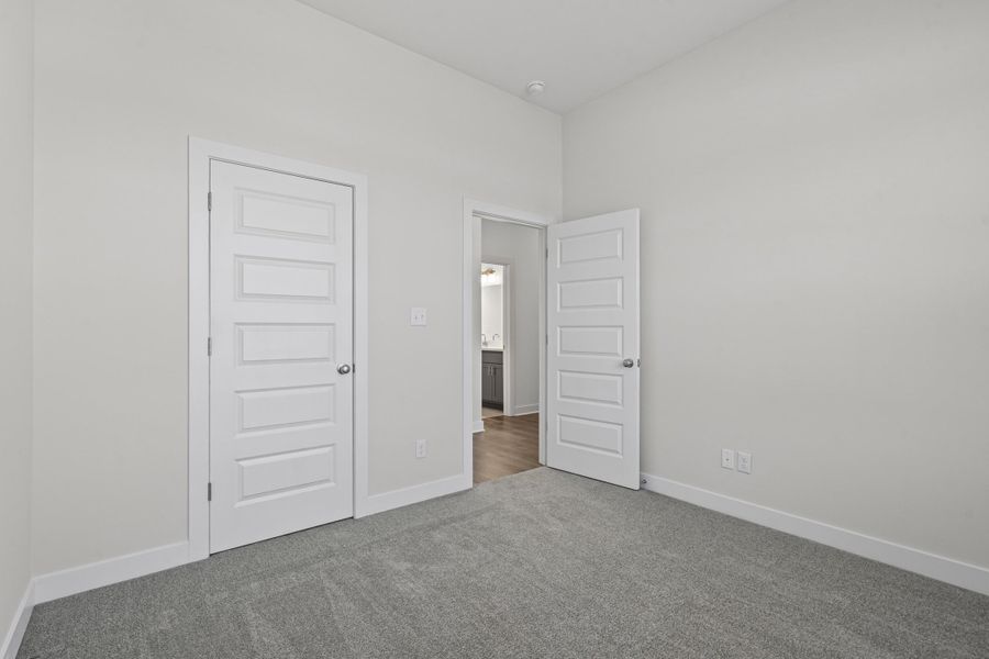 Unfurnished bedroom featuring carpet floors and a closet