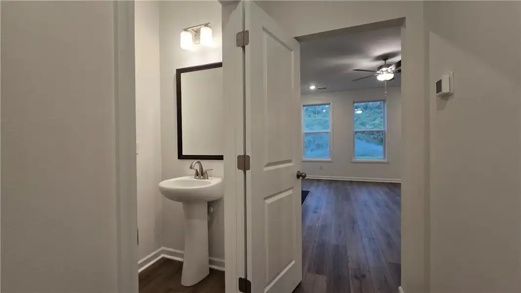 A convenient powder room sits adjacent to a larger
