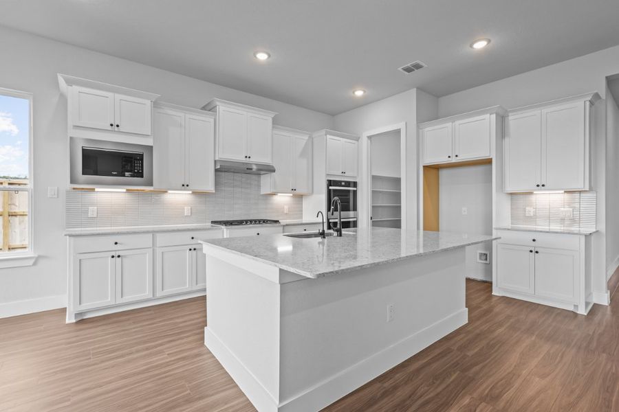 A kitchen with white cabinets. A kitchen with white cabinets.