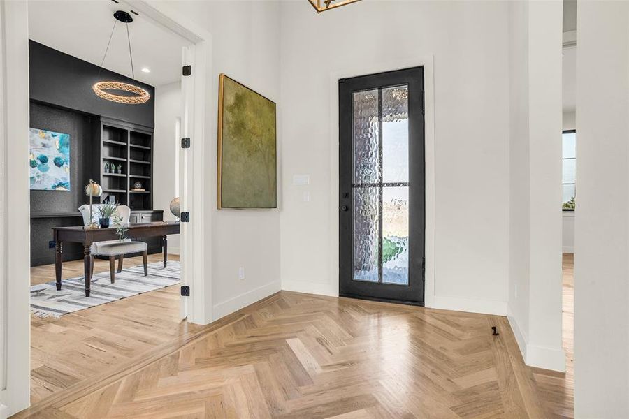 Foyer with baseboards and recessed lighting