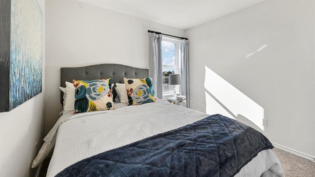 Bedroom with carpet flooring and baseboards