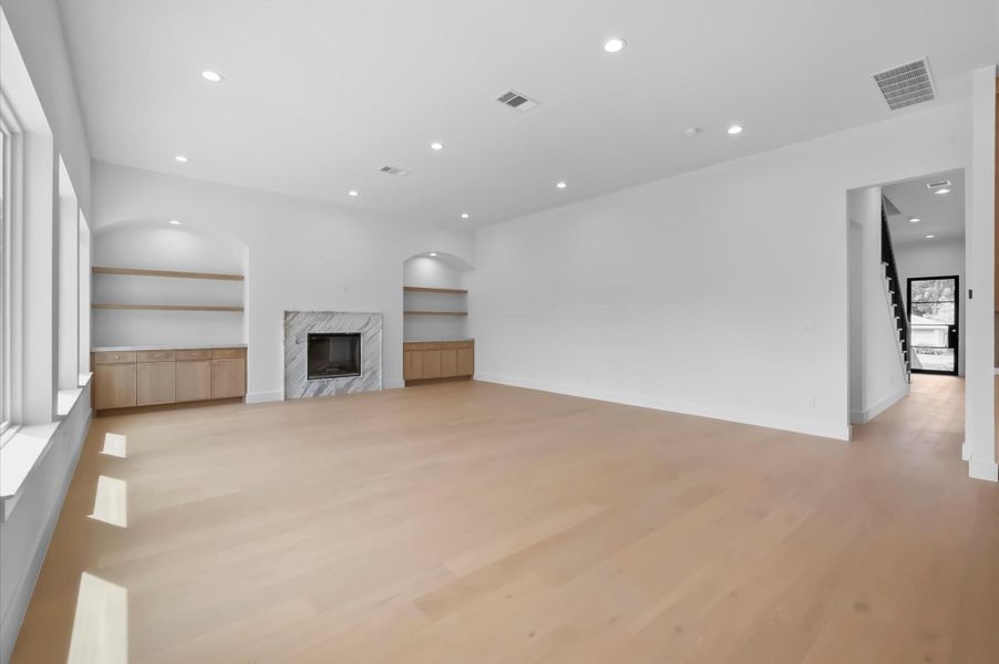 Spacious living room for entertainment and beautiful arches with custom cabinetry. Spacious living room for entertainment and beautiful arches with custom cabinetry.