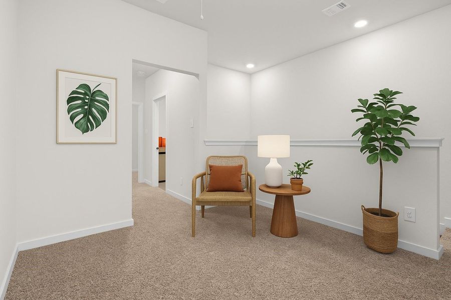 This cozy, well-lit sitting area features neutral carpet, a simple chair with a cushion, a small wooden side table with a lamp, and potted plants. The minimalist decor includes a framed leaf print, creating a calm and inviting atmosphere.