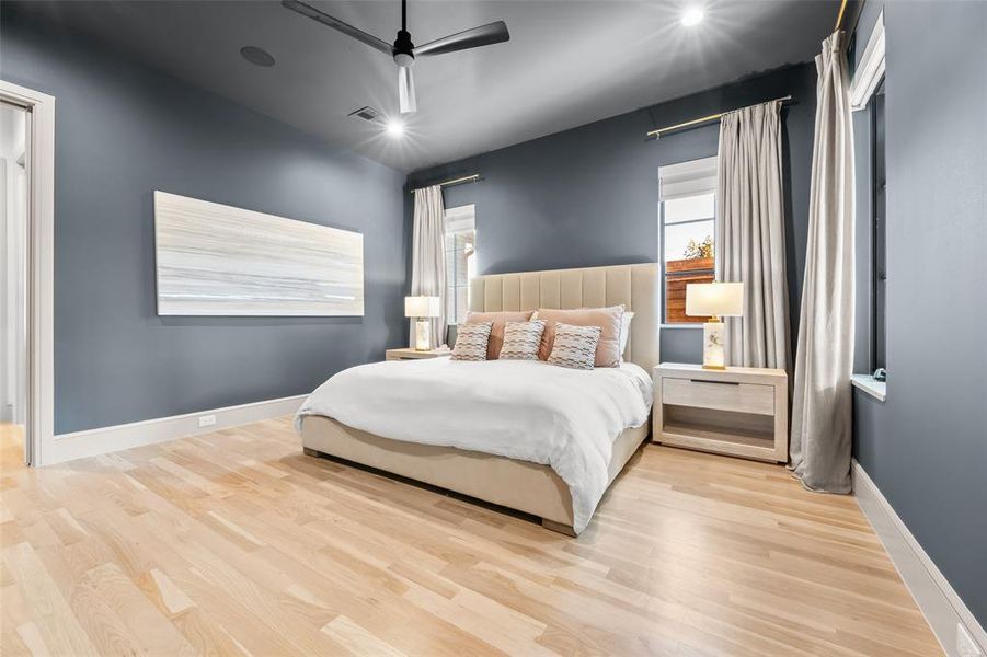Bedroom with light wood-style flooring, a ceiling fan, and recessed lighting