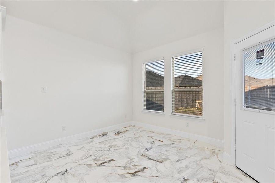 Empty room featuring marble finish floor and baseboards Empty room featuring marble finish floor and baseboards