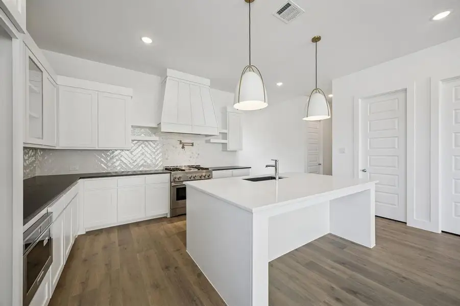 Beautiful cabinetry, gorgeous counter tops and designer backsplash paired with contemporary stainless steel come together to create the kitchen of your dreams!
