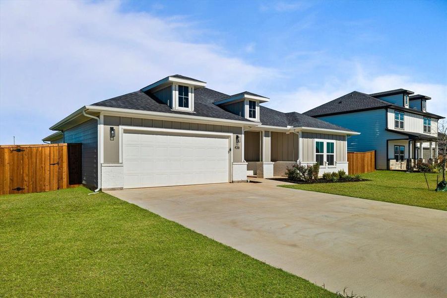 View of front facade with a front yard and a garage