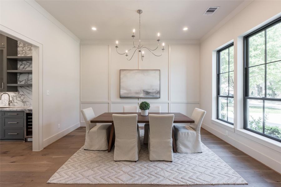 Framed by clean lines and generous openings, Holland Fine Homes composes this dining space through material continuity and balanced scale.