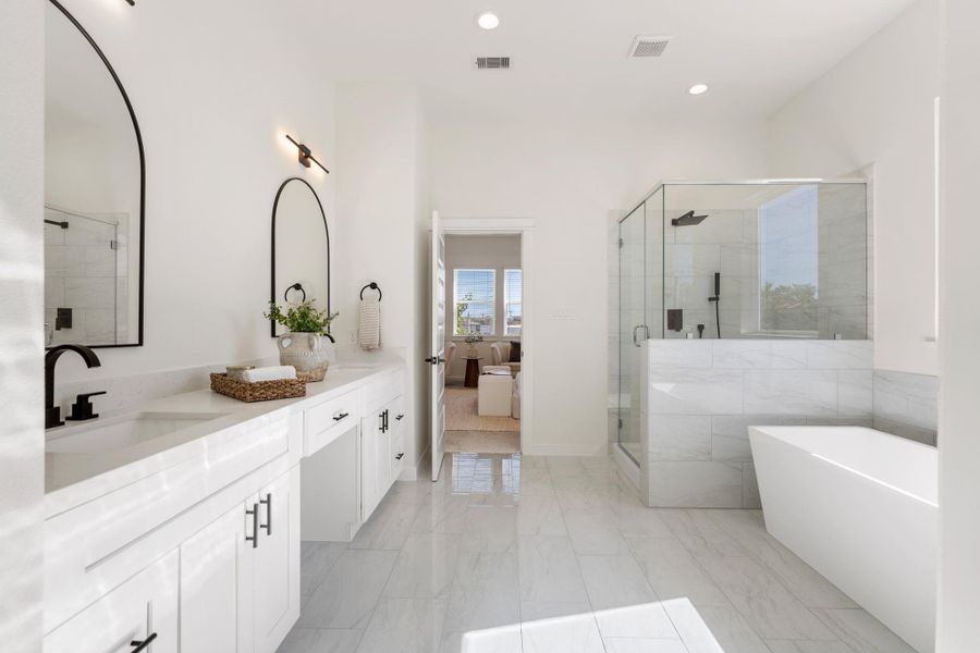 Primarys ensuite bathroom features dual sinks, soaking tub, and seperate walk-in shower.