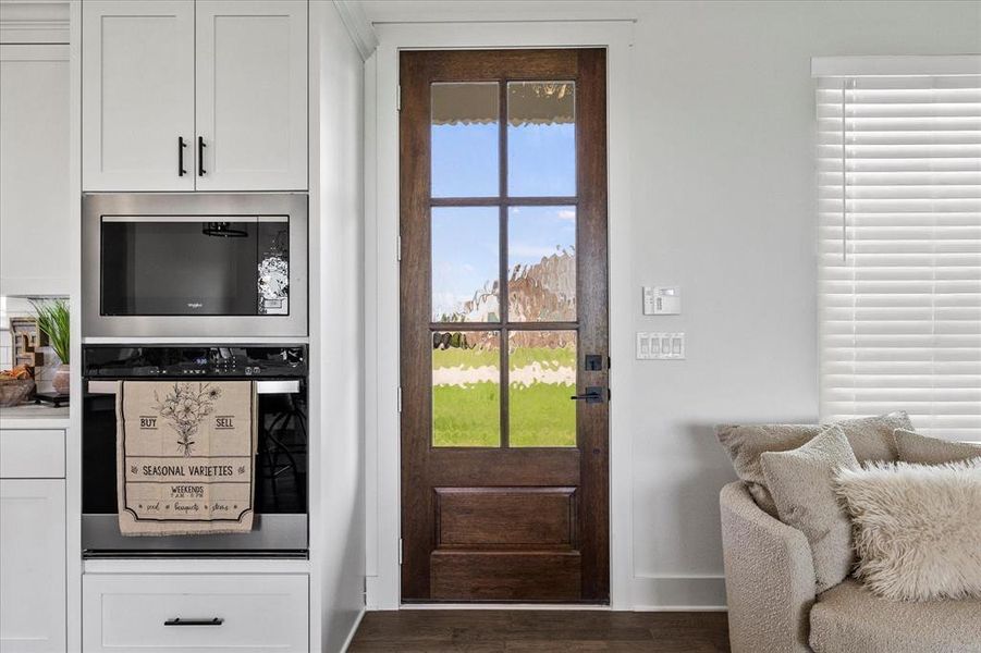 Doorway to outside with dark wood-type flooring