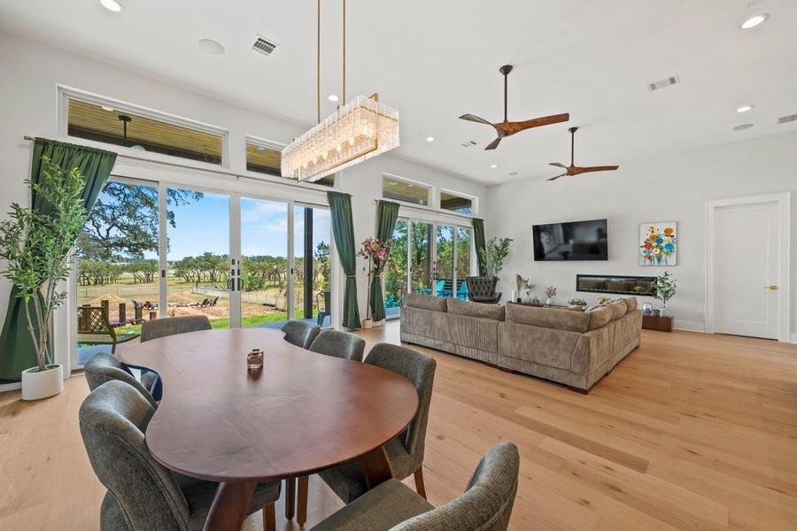 Soaring ceilings, expansive windows, and open-concept living define this light-filled Canyon Lake home. The seamless flow from dining to living space invites both relaxed mornings and lively entertaining—all framed by peaceful Hill Country views.