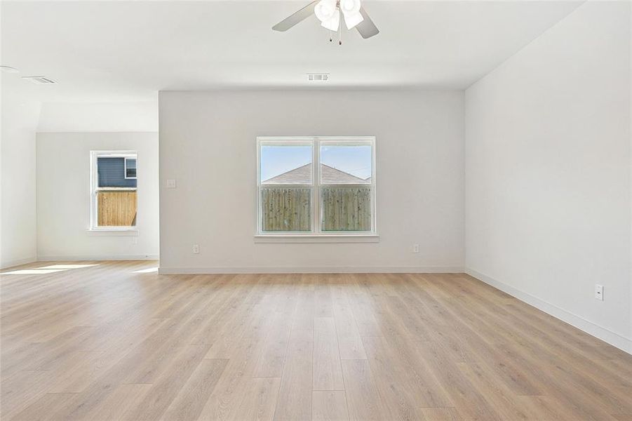 Unfurnished room with ceiling fan and light hardwood / wood-style flooring