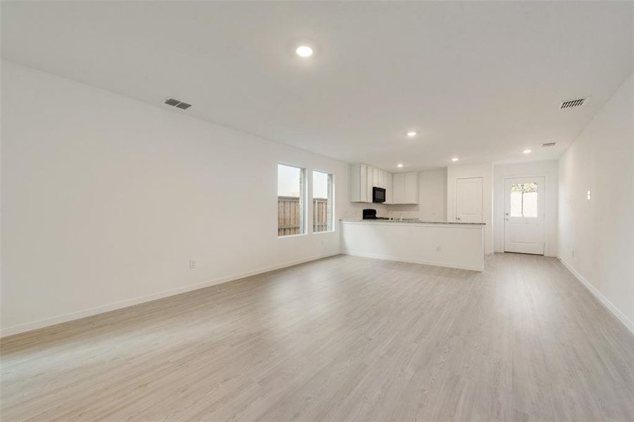 Unfurnished living room with light hardwood / wood-style floors