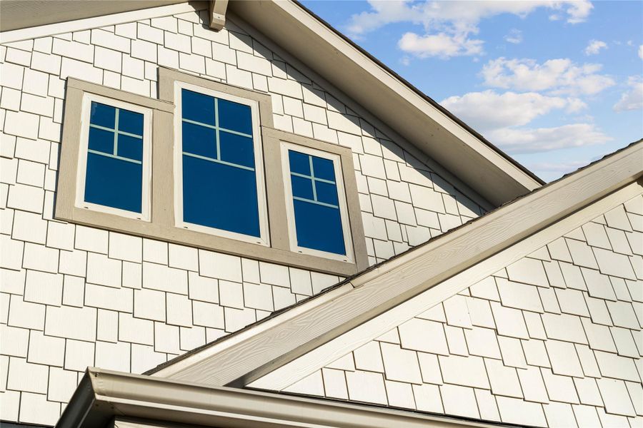 A prominent gabled roofline frames a trio of vertically oriented casement windows in this beautiful elevation of 630 Running Iron. A prominent gabled roofline frames a trio of vertically oriented casement windows in this beautiful elevation of 630 Running Iron.