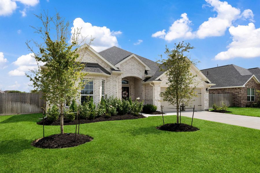 Front exterior of a new home in Champions Forest 90', Mont Belvieu, TX, highlighting curb appeal (Image 24).