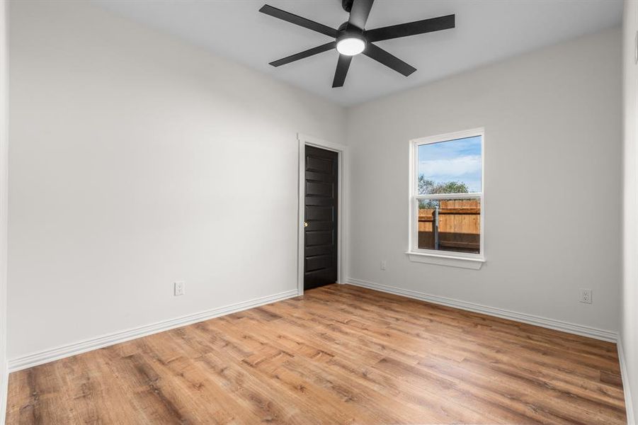 Empty room featuring light wood finished floors and ceiling fan Empty room featuring light wood finished floors and ceiling fan