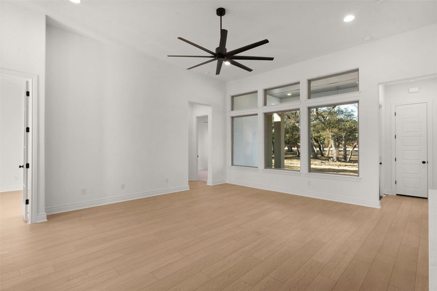 Unfurnished living room featuring ceiling fan, light wood-style floors, and recessed lighting