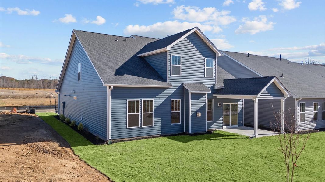 Vibrant rear outdoor space featuring a covered porch and exceptional craftsmanship
