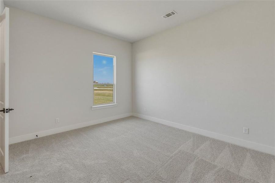 Carpeted interior room with light gray walls Carpeted interior room with light gray walls