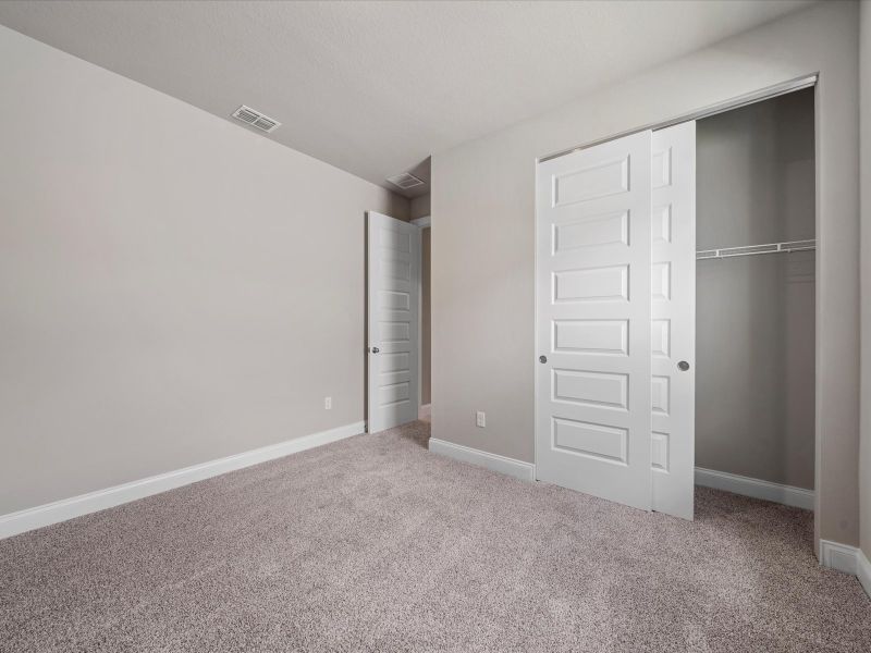 Bedroom in the Coral floorplan at 6326 NW Sweetwood Drive in Brystol at Wylder