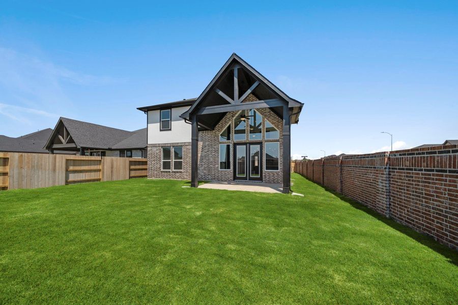 Gorgeous rear elevation with a huge back covered patio complete with a ceiling fan. Gorgeous rear elevation with a huge back covered patio complete with a ceiling fan.