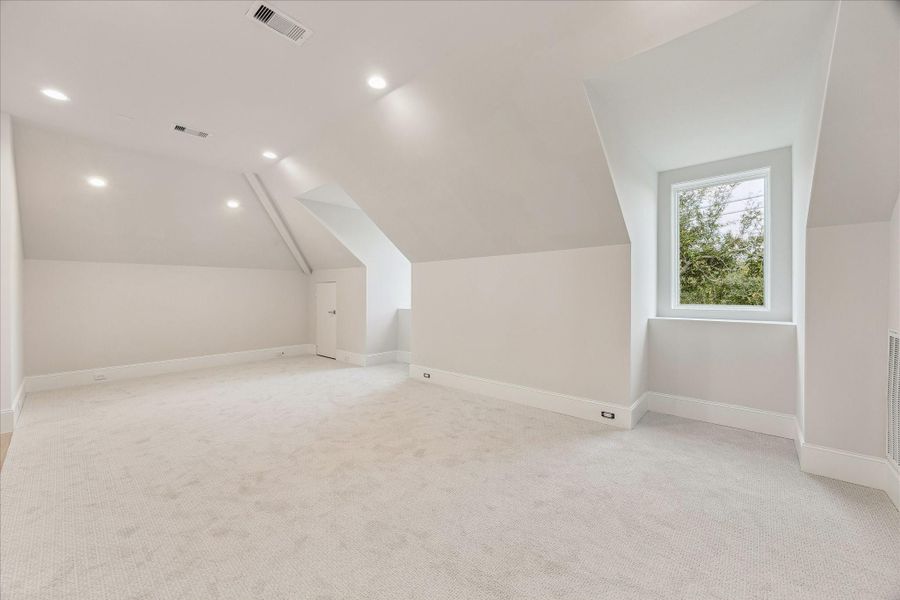 As you enter the third floor, you step into the spacious gameroom with access to a full bathroom.