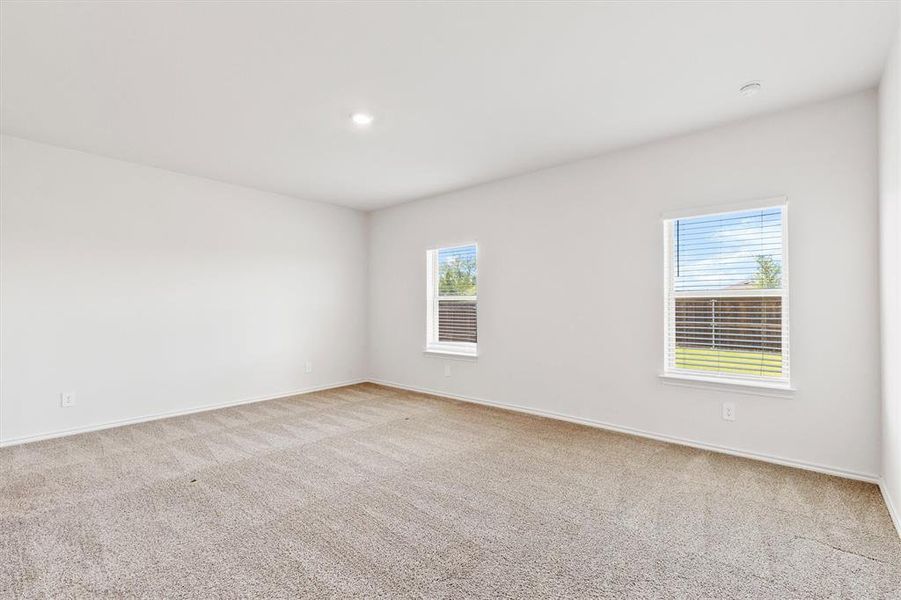 Carpeted room with white walls, two windows, and recessed lighting