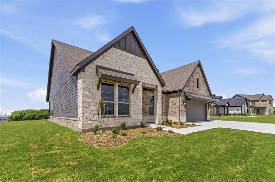 View of front of house with a front lawn, driveway, stone siding, and a shingled roof View of front of house with a front lawn, driveway, stone siding, and a shingled roof