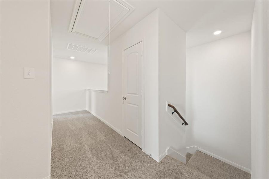 Hall featuring light carpet, attic access, and recessed lighting Hall featuring light carpet, attic access, and recessed lighting