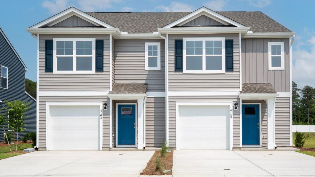 Front exterior of a new home in Townes at Seabrooke, Leland, NC, highlighting curb appeal (Image 1). Front exterior of a new home in Townes at Seabrooke, Leland, NC, highlighting curb appeal (Image 1).