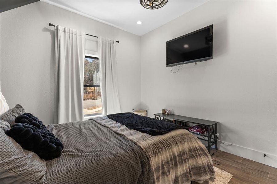 Bedroom featuring wood finished floors and baseboards Bedroom featuring wood finished floors and baseboards