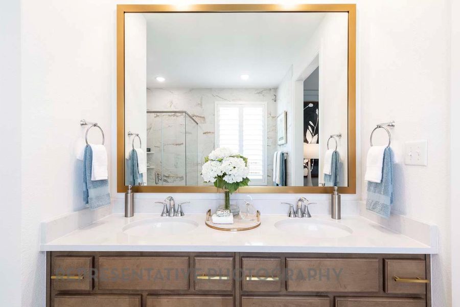 Full bathroom with double vanity and a marble finish shower Full bathroom with double vanity and a marble finish shower
