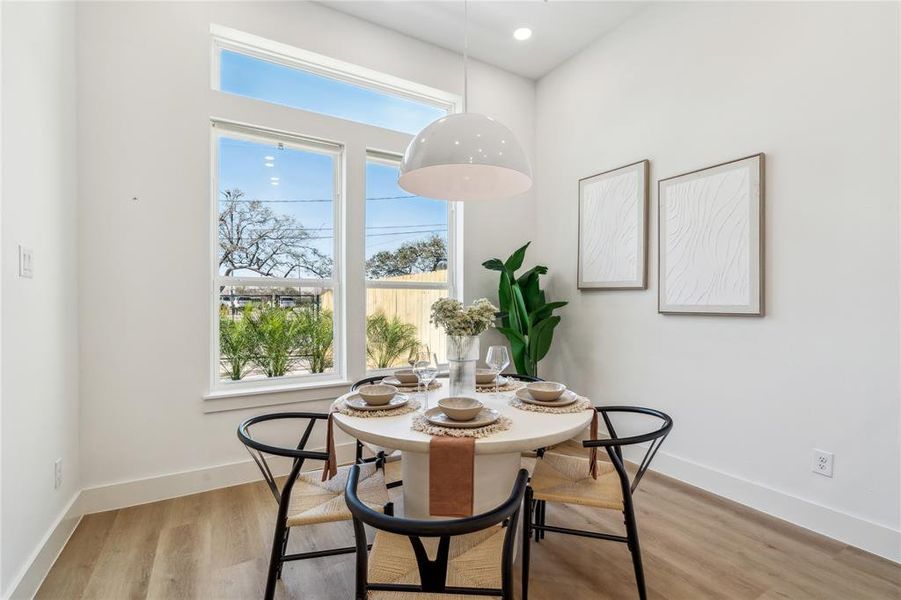 Bright and inviting, this stylish dining space welcomes you upon entry with abundant natural light, modern elegance, and a seamless connection to the outdoors with the view of your courtyard—perfect for intimate gatherings or everyday meals.